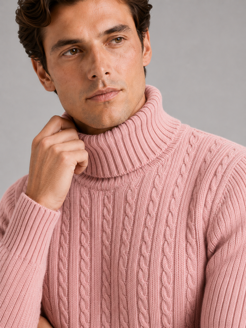Close up of pink cable knit turtleneck showing thick textured fabric and warm collar detail