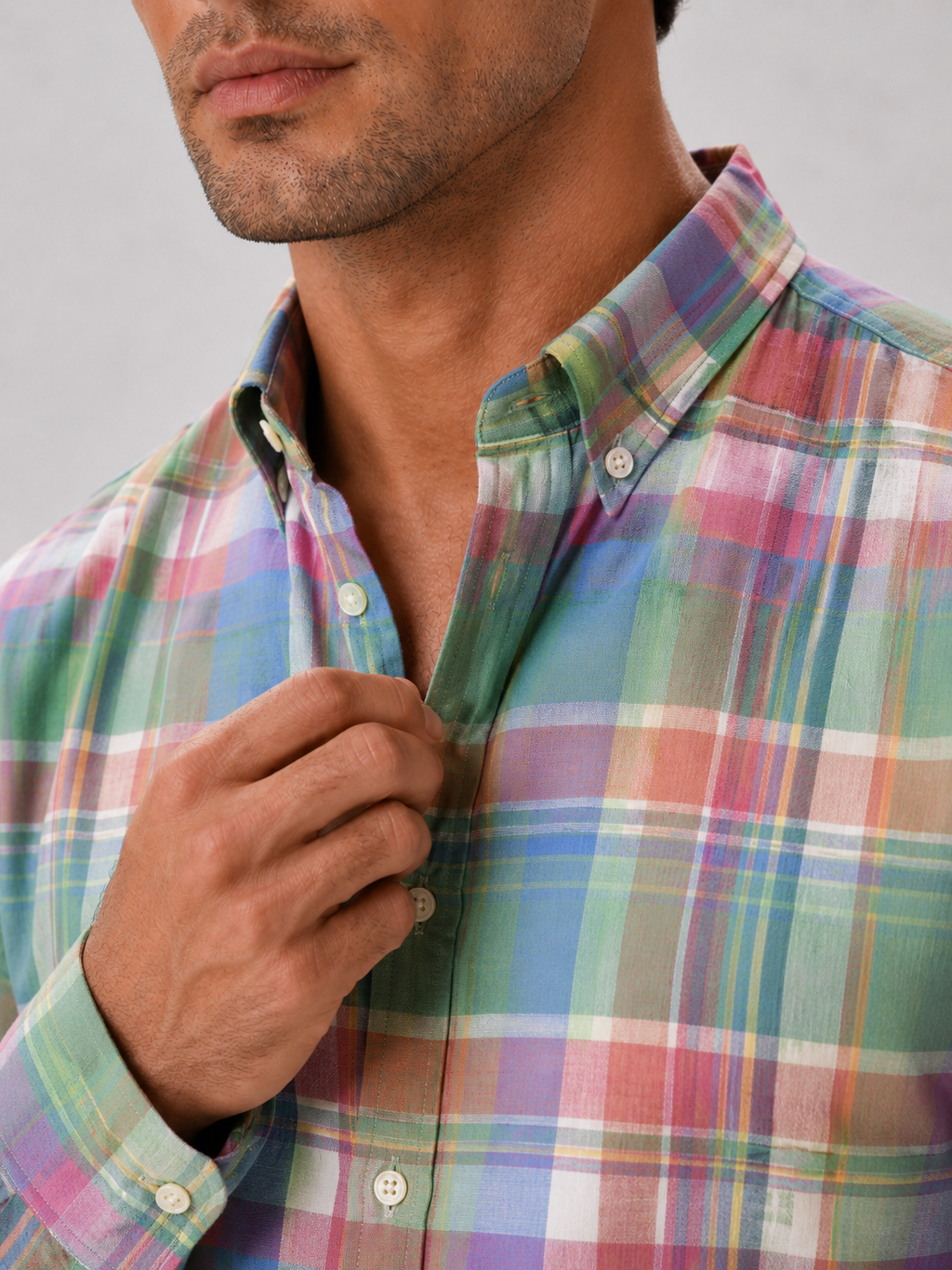 Close up of pink madras shirt showing soft cotton fabric and plaid striped pattern detail
