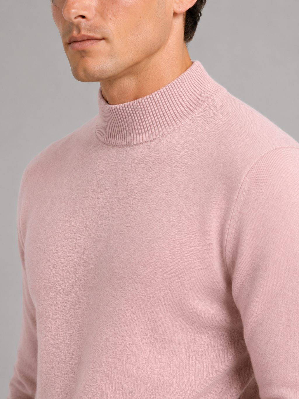 Close up of pink mock neck sweater showing soft knit texture and refined collar detail