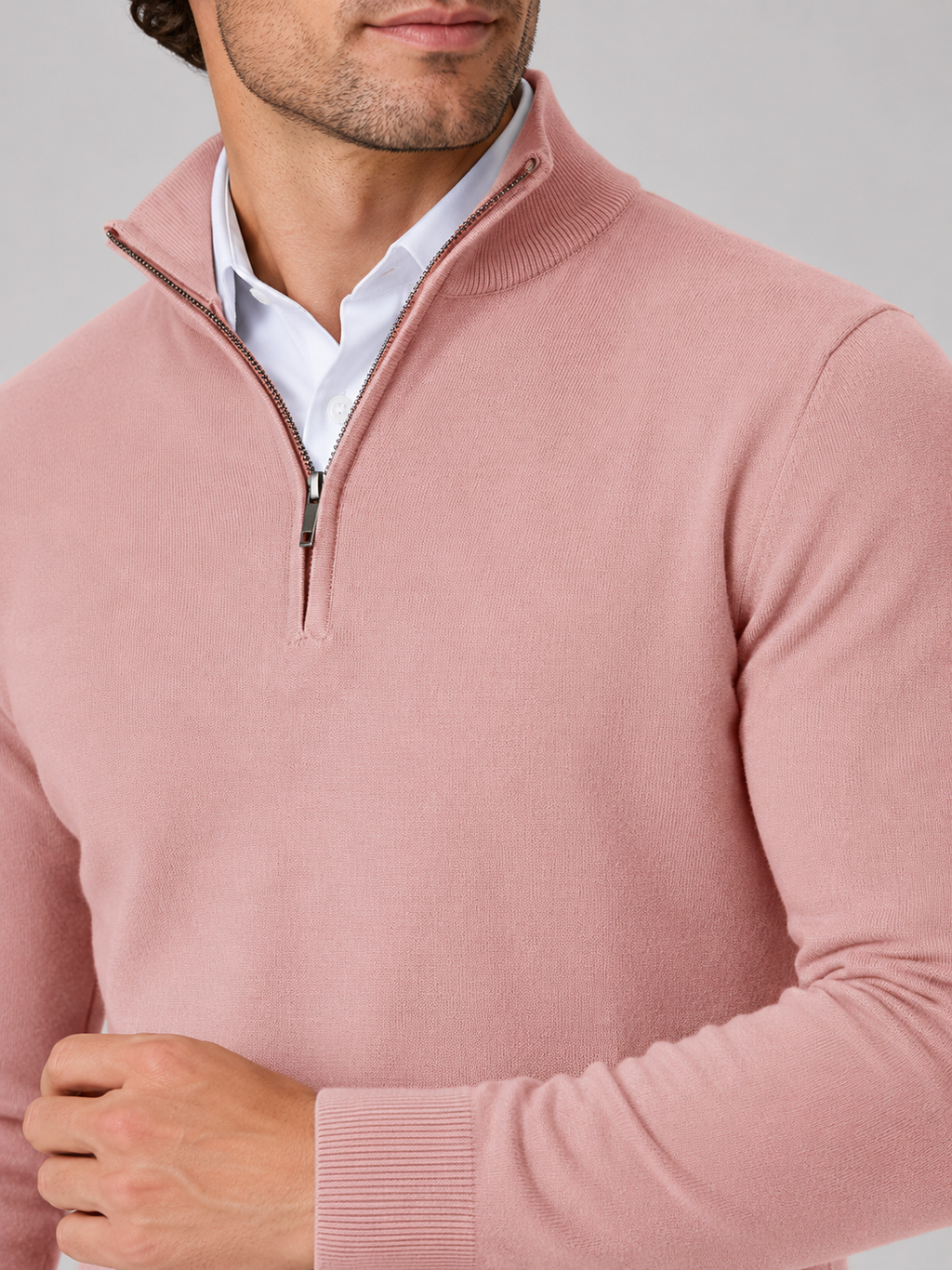 Close up of pink quarter zip sweater showing soft knit texture and mock neck zipper detail