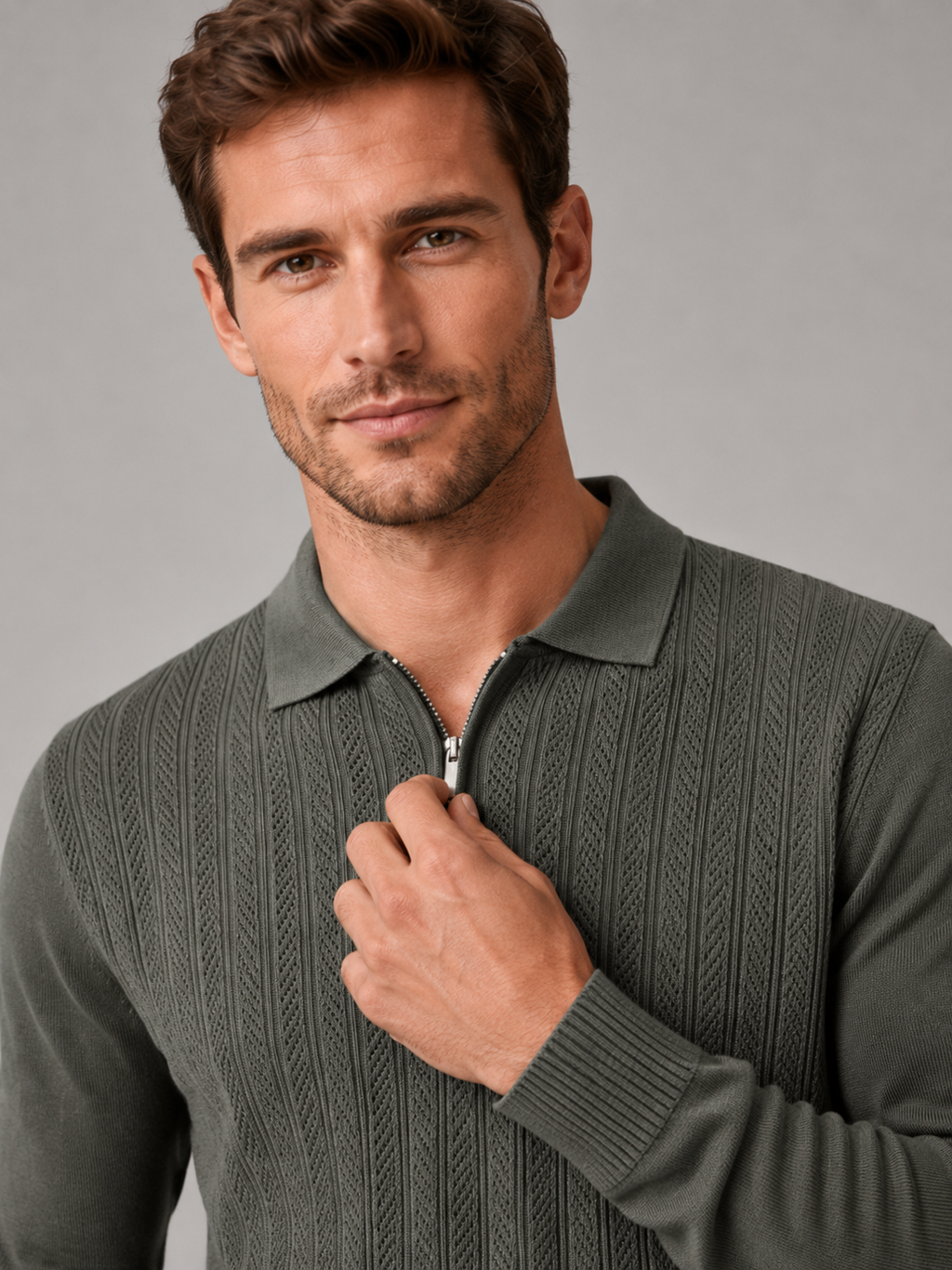 Close-up of a green quarter zip polo shirt showing the textured fabric, zipper placket, polo collar, cuffs, hem, and stitching details