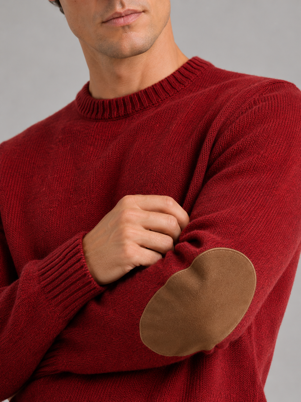 Close up of red wool knit sweater showing thick warm texture and clean crew neck detail