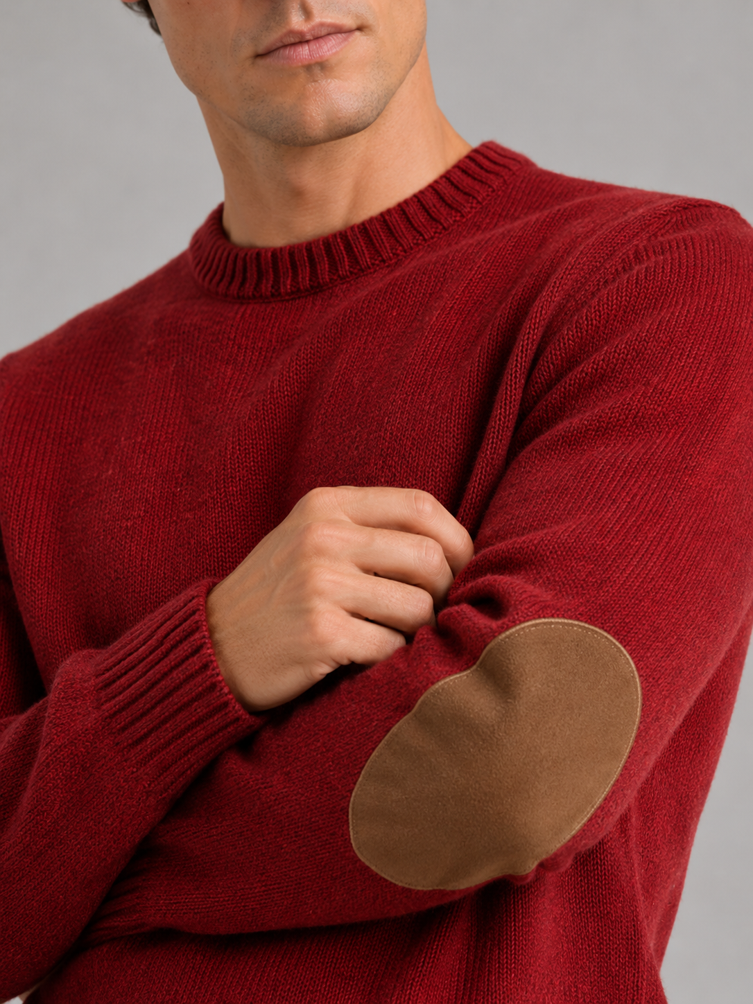 Close up of red wool knit sweater showing thick warm texture and clean crew neck detail