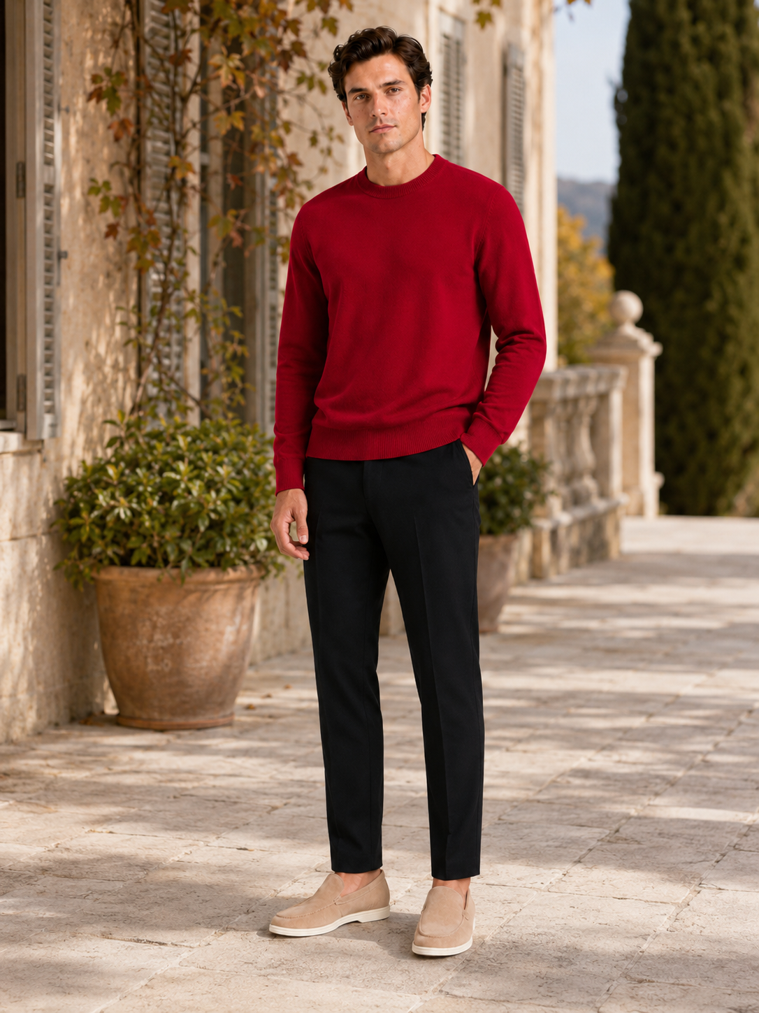 Man styling red crewneck sweater in a warm everyday fall winter lifestyle outfit