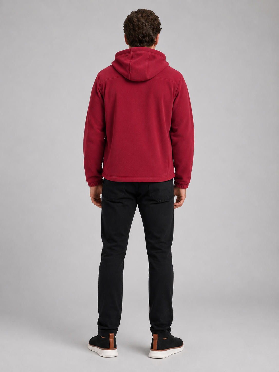Back view of a man wearing a red hooded fleece jacket showing the attached hood, thick fleece construction, long sleeves, and comfortable outdoor fit