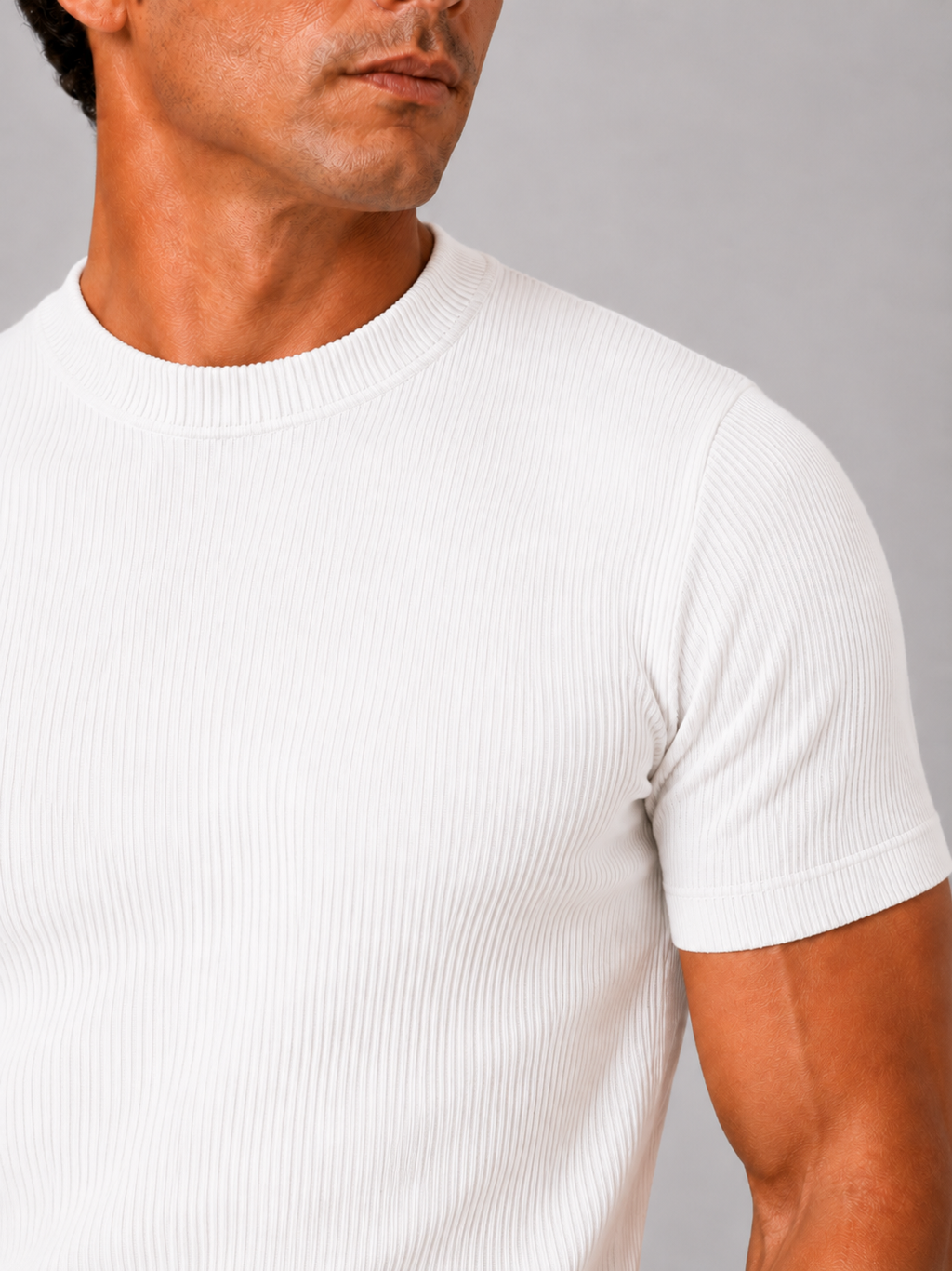 Close up of white ribbed t shirt showing soft stretch fabric and textured crew neck detail