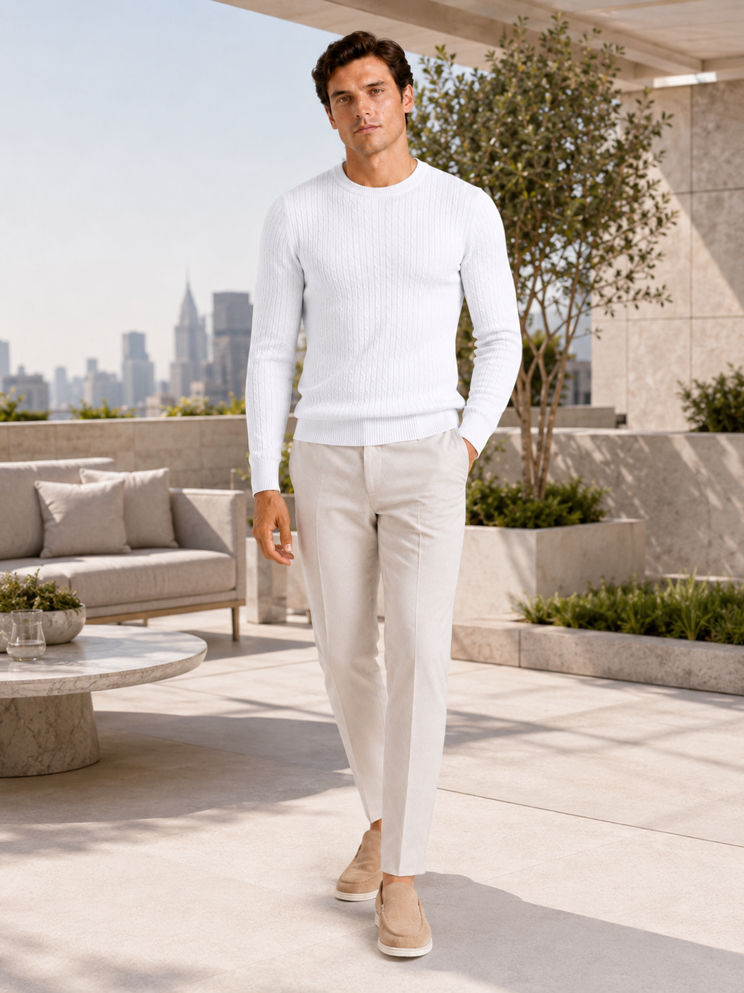 Man styling wine cable knit crew neck sweater in a refined spring lifestyle outfit
