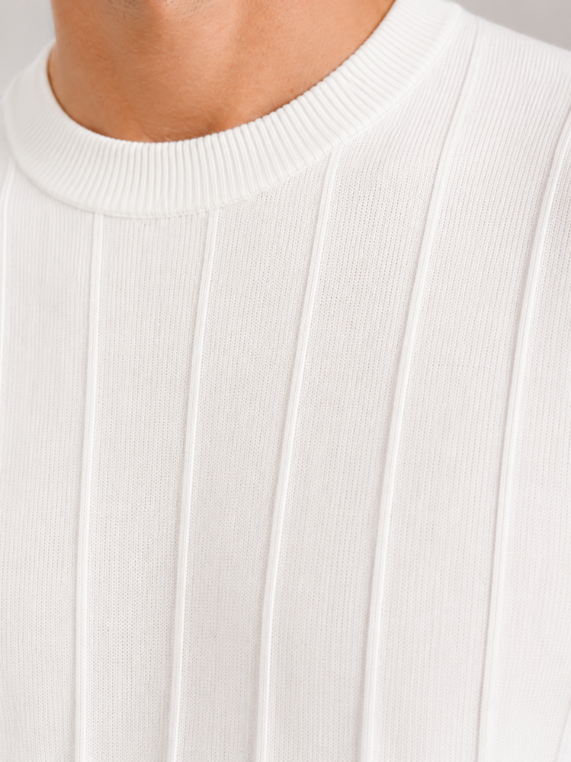 Close up of white knit t shirt fabric showing soft breathable ribbed texture and refined finish
