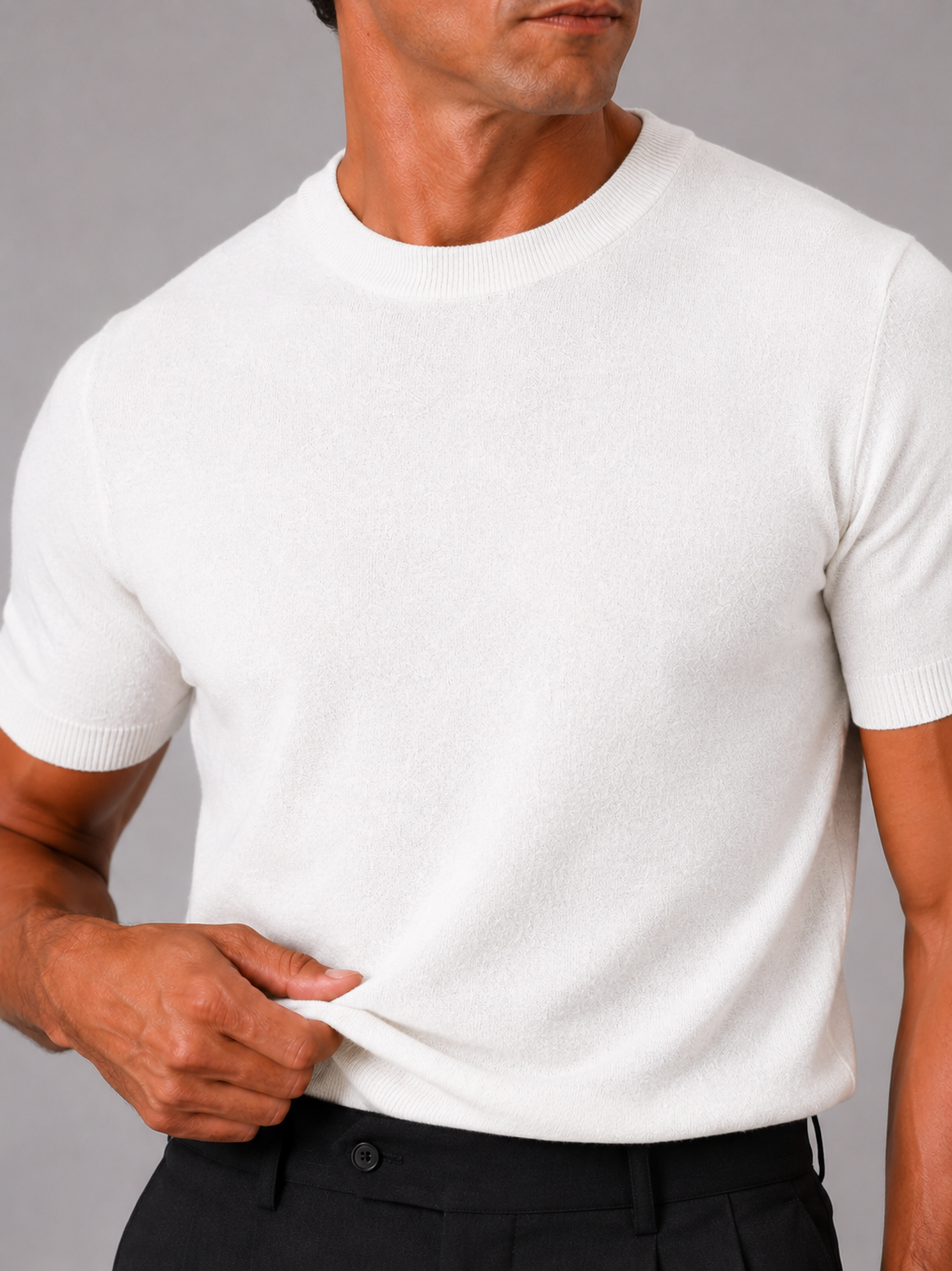 Close up of white knit t shirt showing soft breathable texture and clean crew neck detail