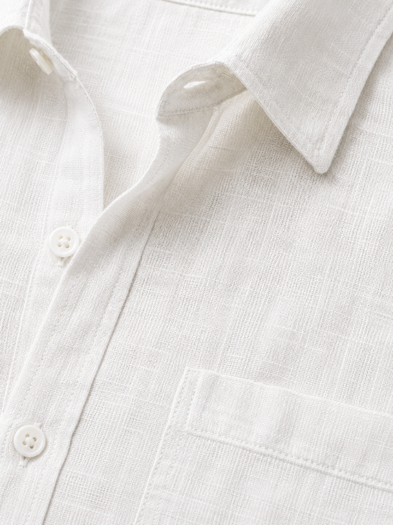 Close up of white linen shirt fabric showing soft breathable natural woven texture