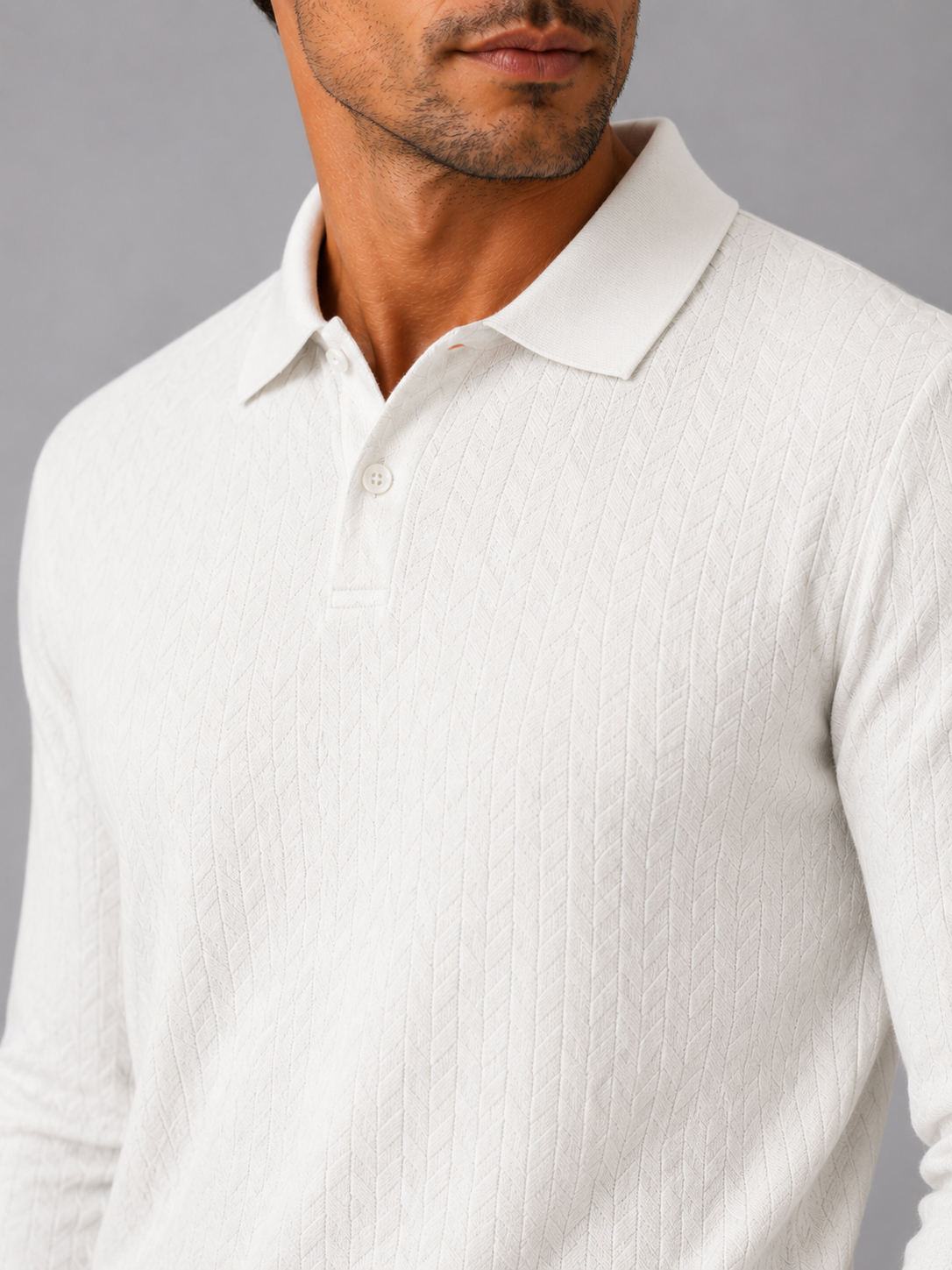 Close up of white knit polo shirt showing soft textured fabric and refined collar detail