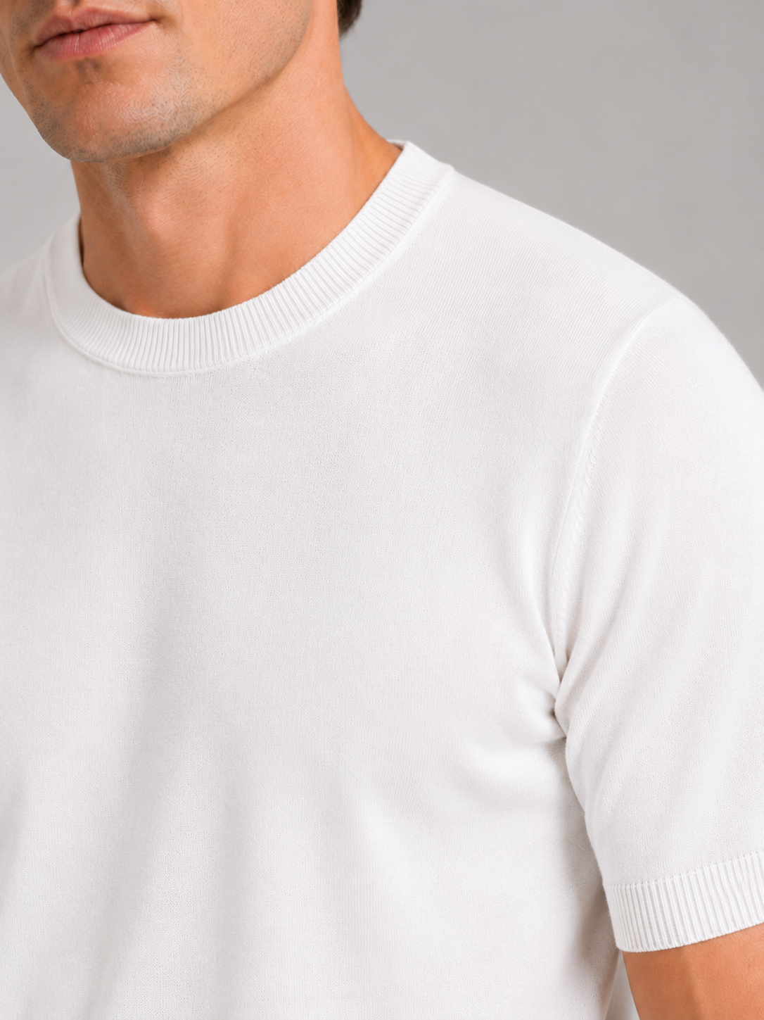Close up of white merino wool knit t shirt showing soft breathable texture and crew neck detail