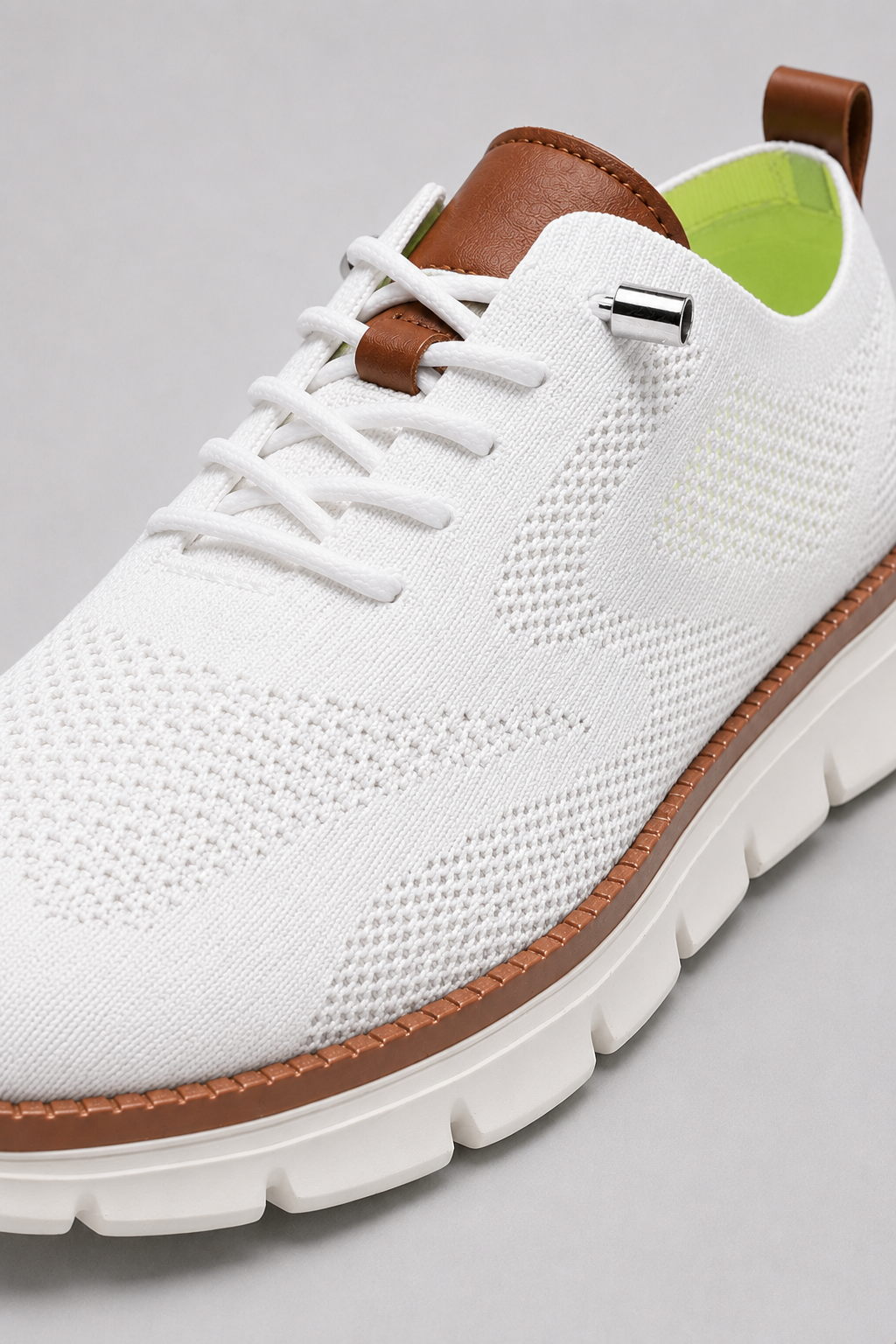 Close up of white mesh sneakers showing breathable knit upper and cushioned sole detail