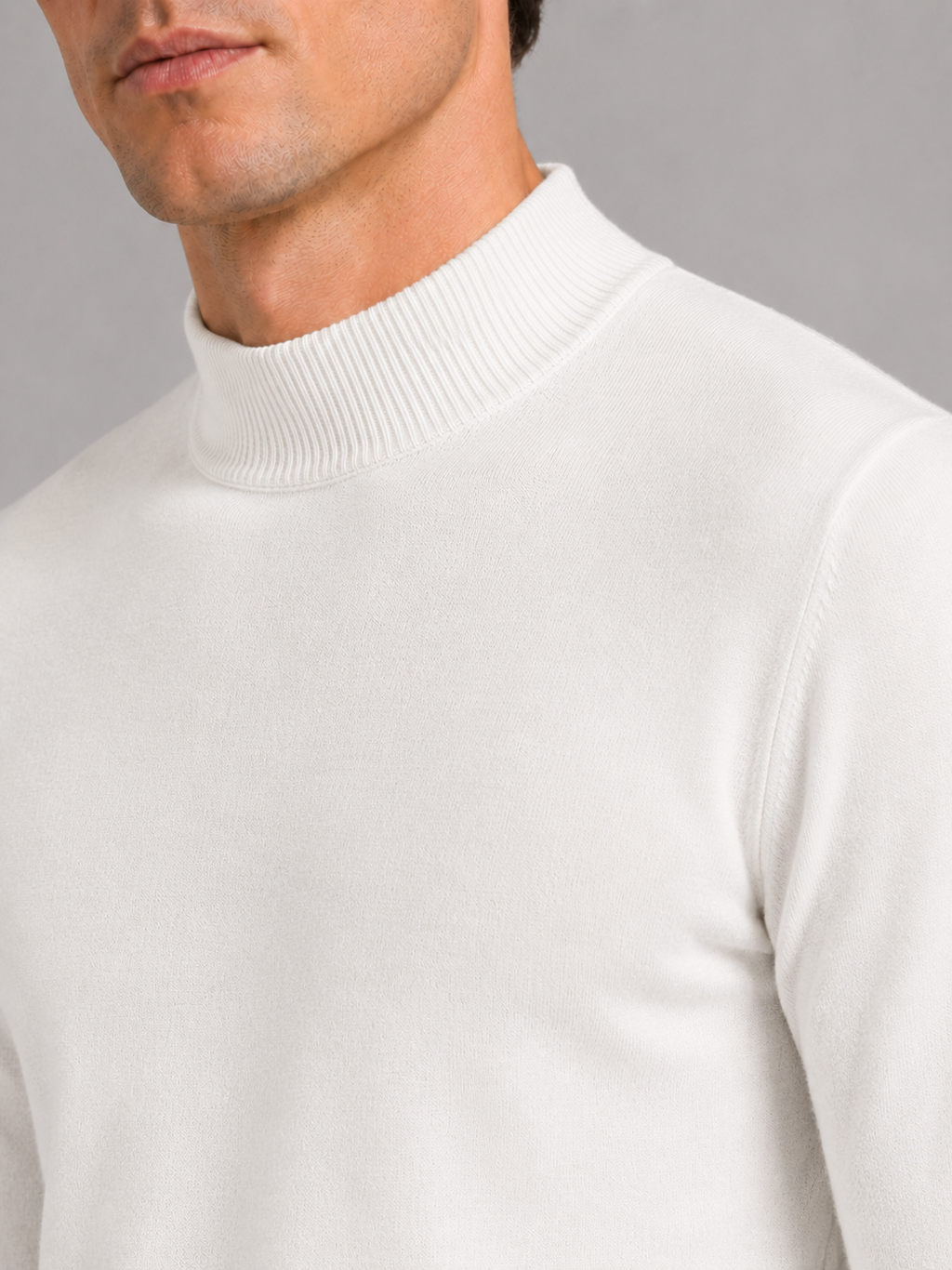 Close up of white mock neck sweater showing soft knit texture and refined collar detail