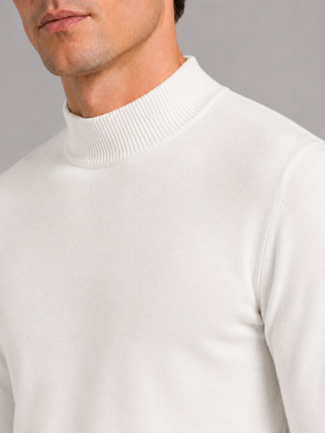 Close up of white mock neck sweater showing soft knit texture and refined collar detail