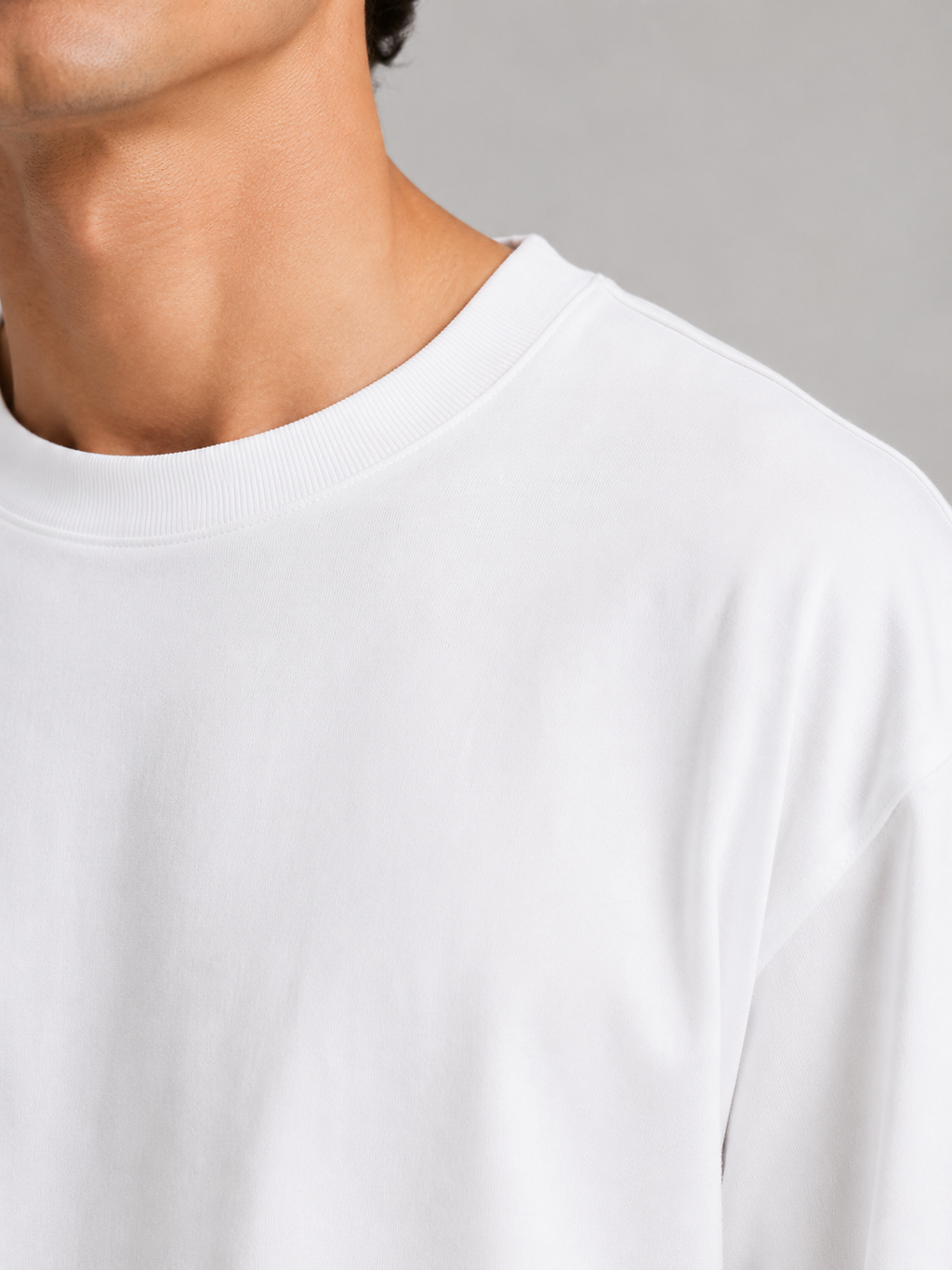 Close up of white t shirt fabric showing soft lightweight breathable cotton texture