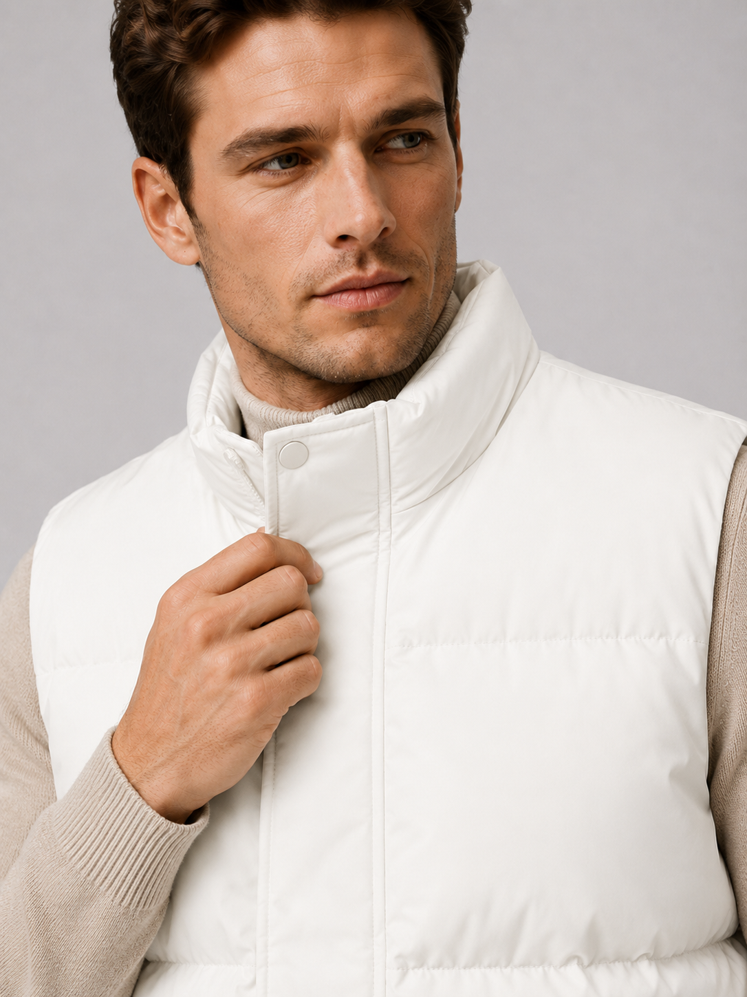 Back view of a man wearing a white puffer vest showing the quilted construction, stand collar, and comfortable fit