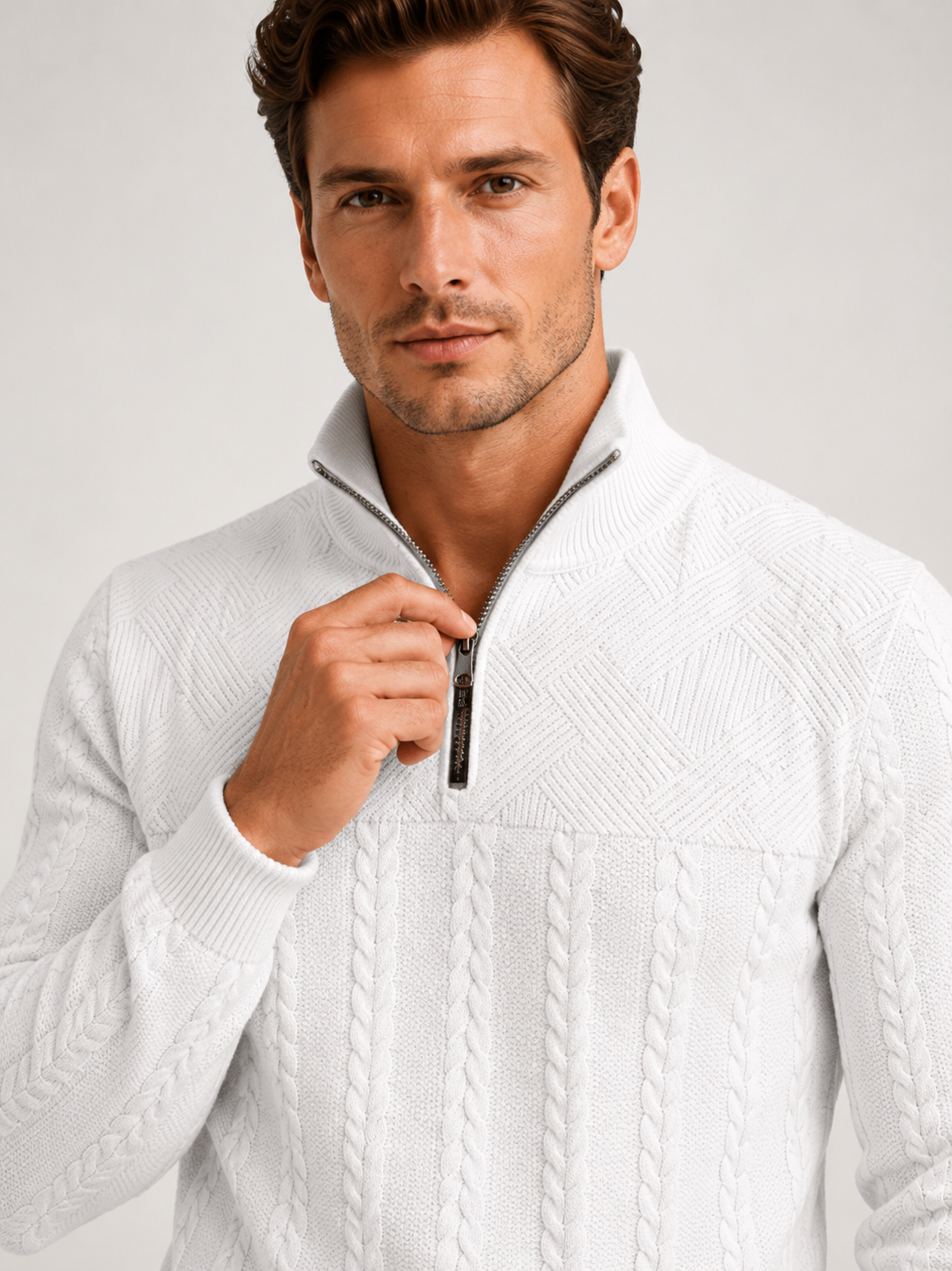 Close up of white jacquard sweater showing textured knit pattern, quarter zip, and warm fabric detail