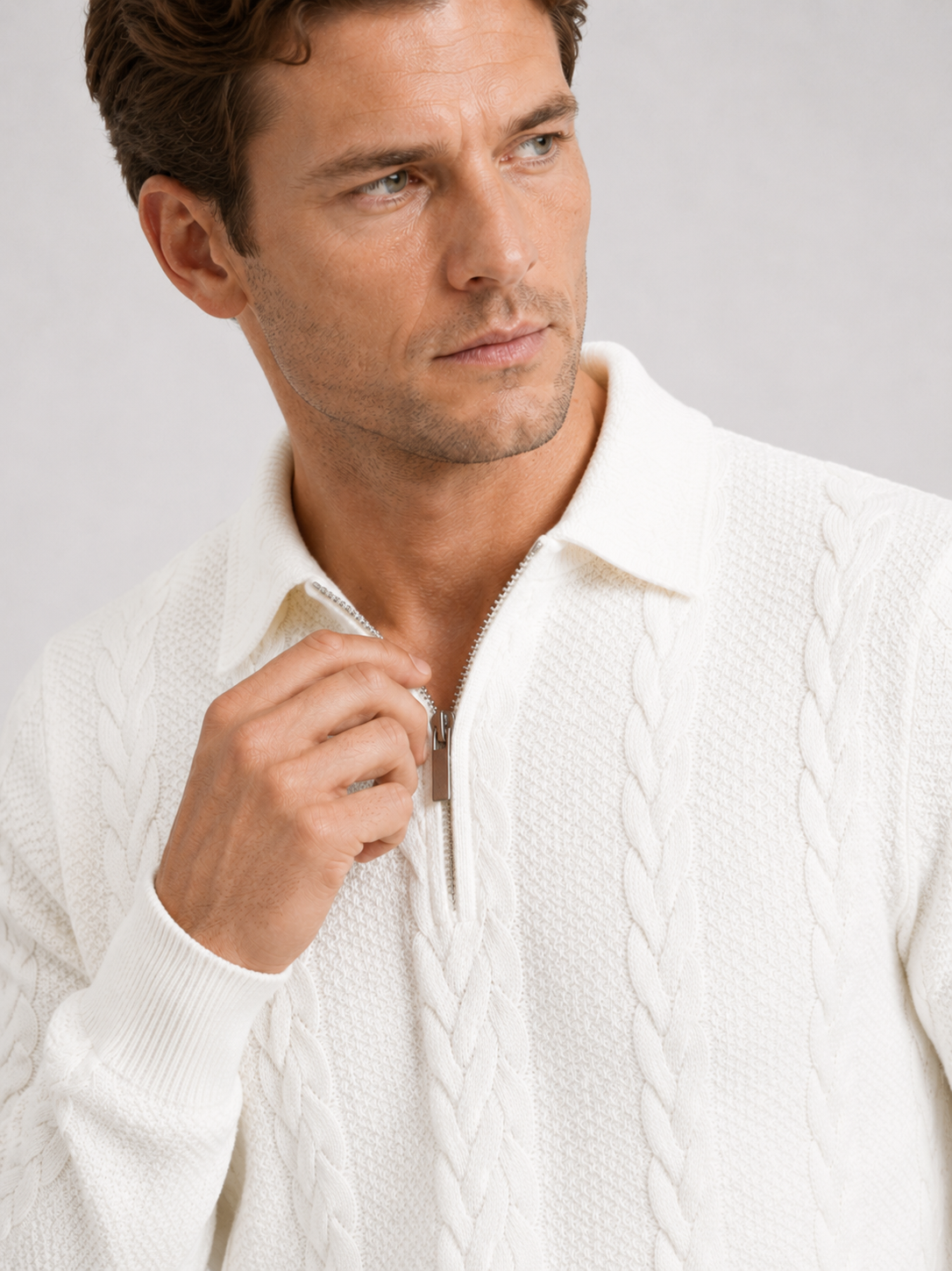 Close up of white quarter zip sweater showing soft knit texture, turn down collar, and zipper detail