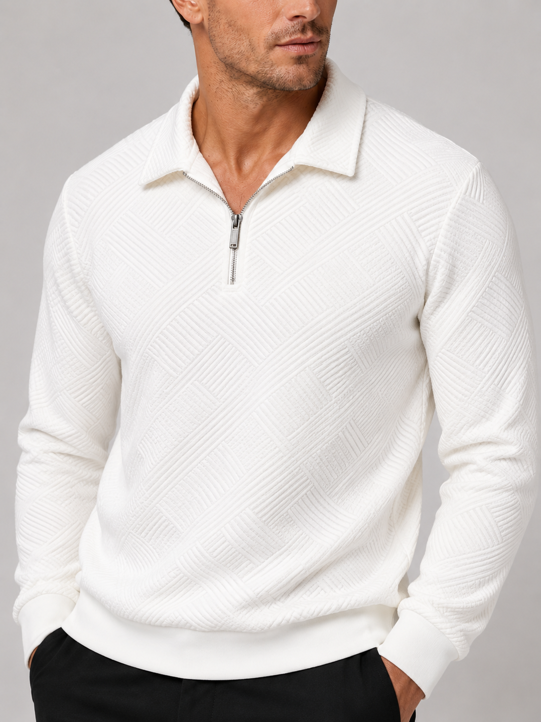 Close-up of a white quarter zip polo sweater showing the fine knit texture, polo collar, zipper, cuffs, and stitching