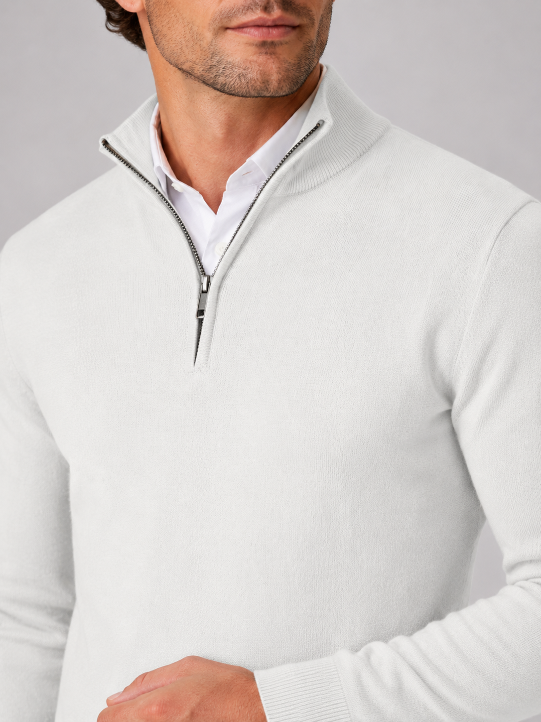 Close up of white quarter zip sweater showing soft knit texture and mock neck zipper detail