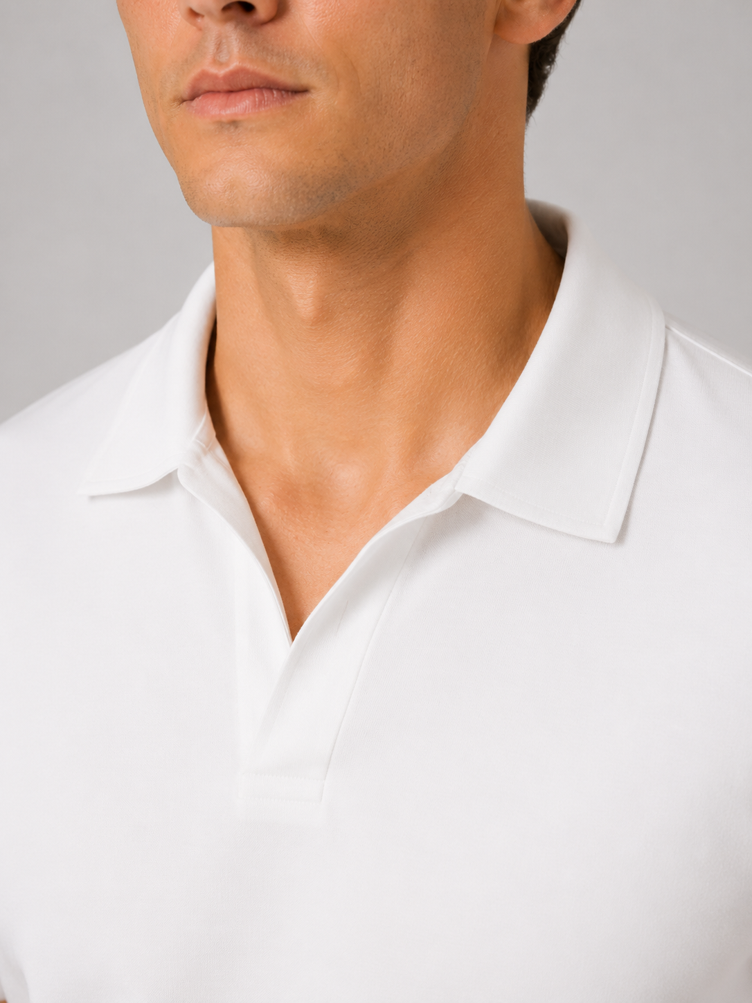 Close up of white polo shirt showing smooth silky fabric and refined collar detail