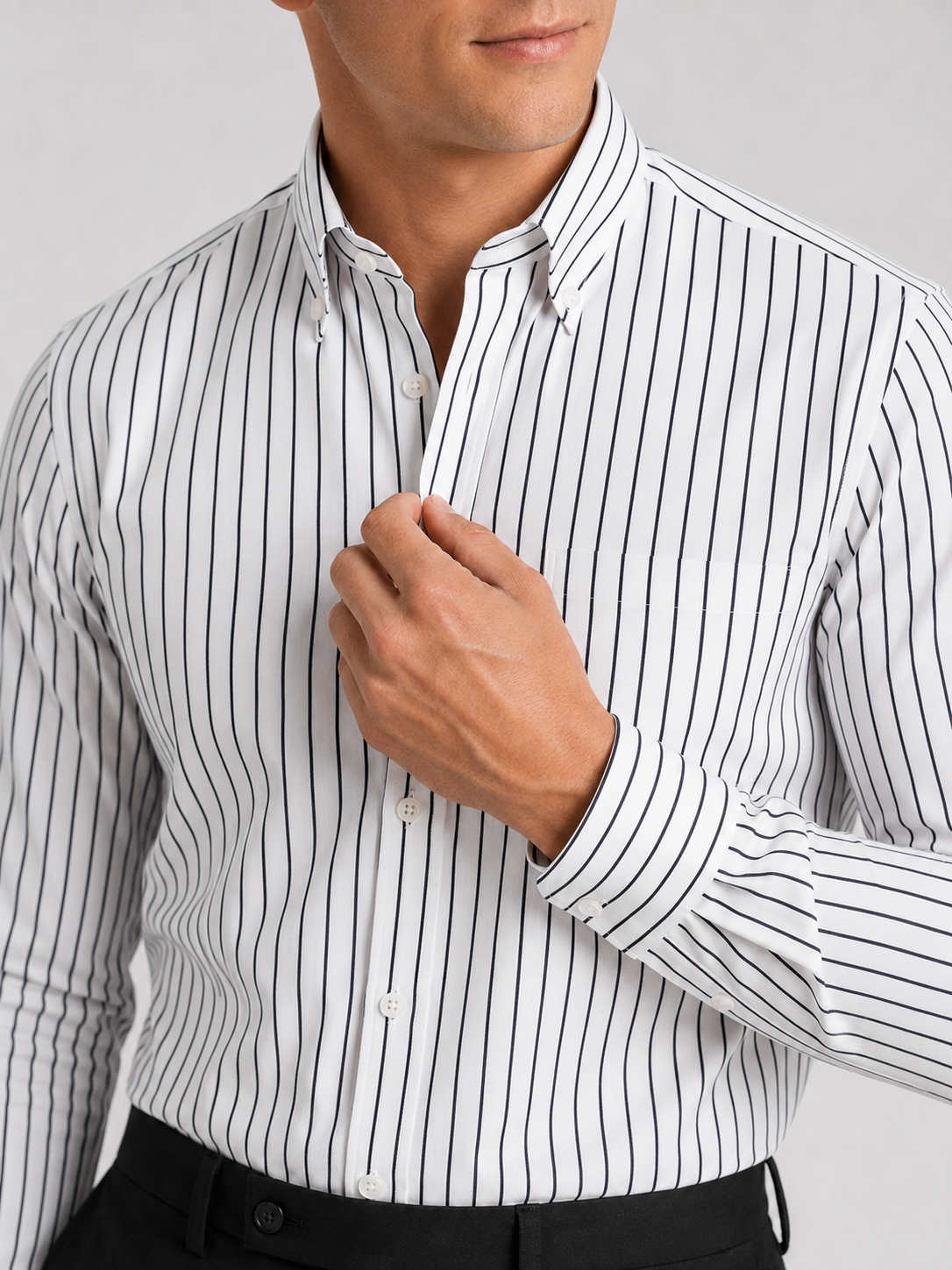 Close up of white striped dress shirt showing crisp fabric and refined collar detail