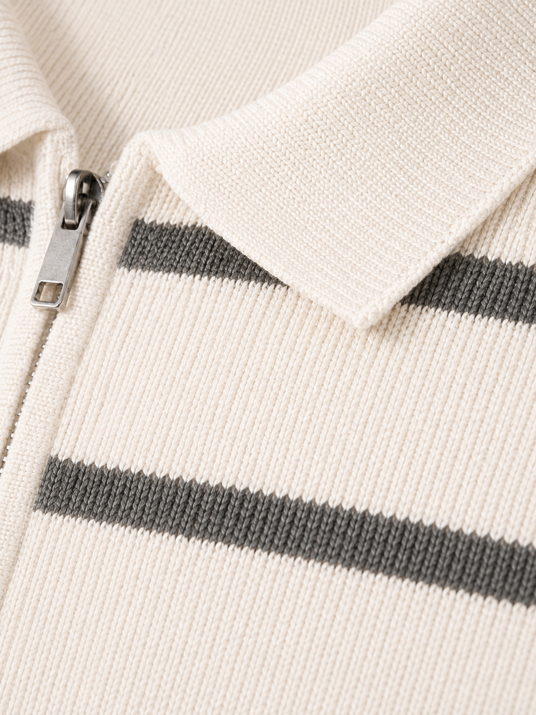 Close up of white striped knit polo fabric showing soft breathable texture and quarter zip detail