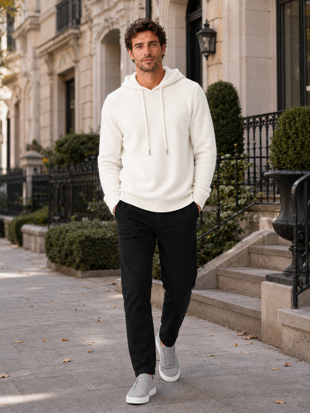 Man wearing a white wool hoodie sweater in a casual fall winter outfit for everyday wear