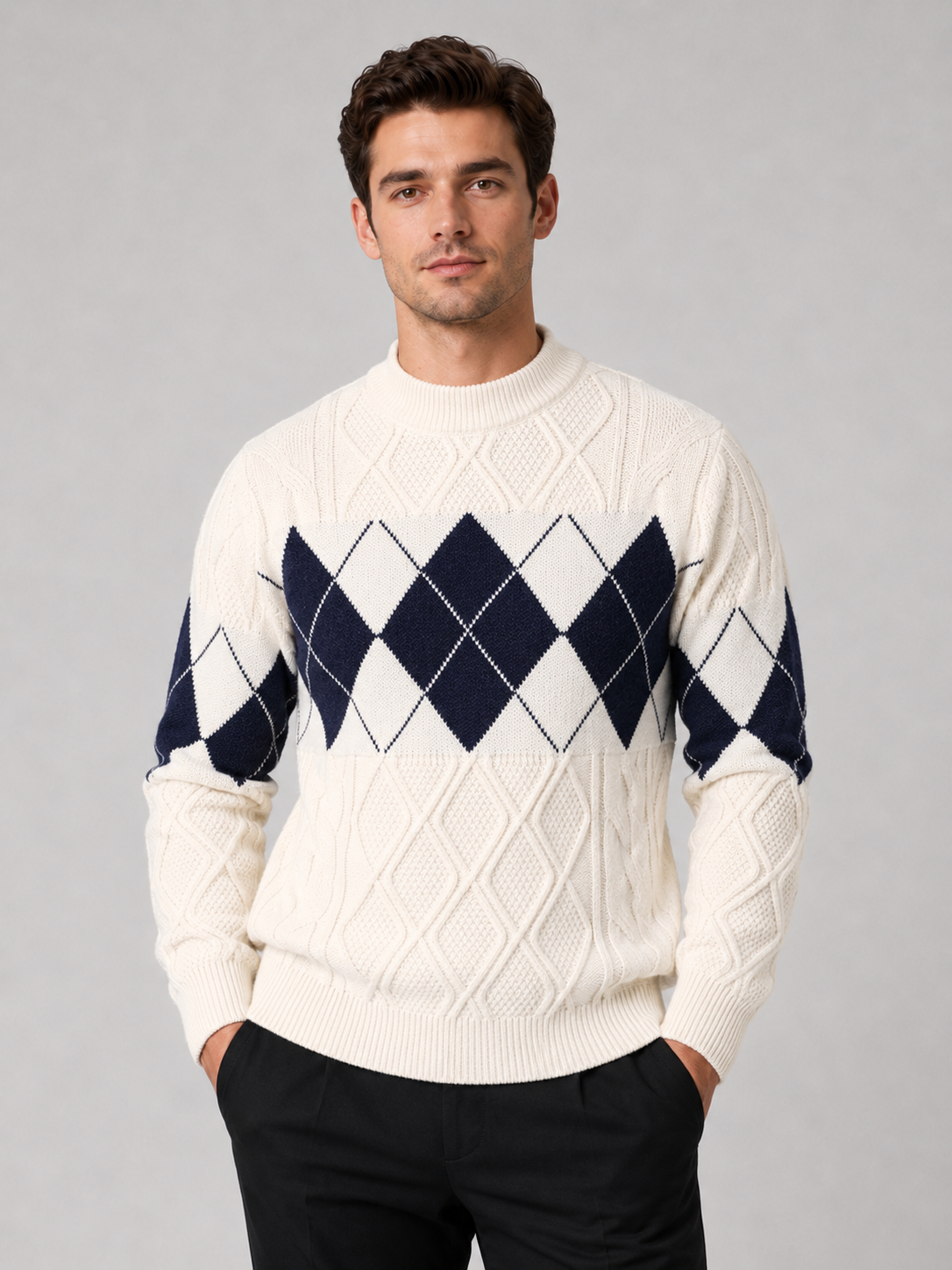 Front view of a man wearing a white argyle cable knit sweater with a mock neck, patchwork design, long sleeves, and warm knit construction