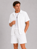 Men wearing white corduroy button up shirt and shorts set summer vacation outfit beach style