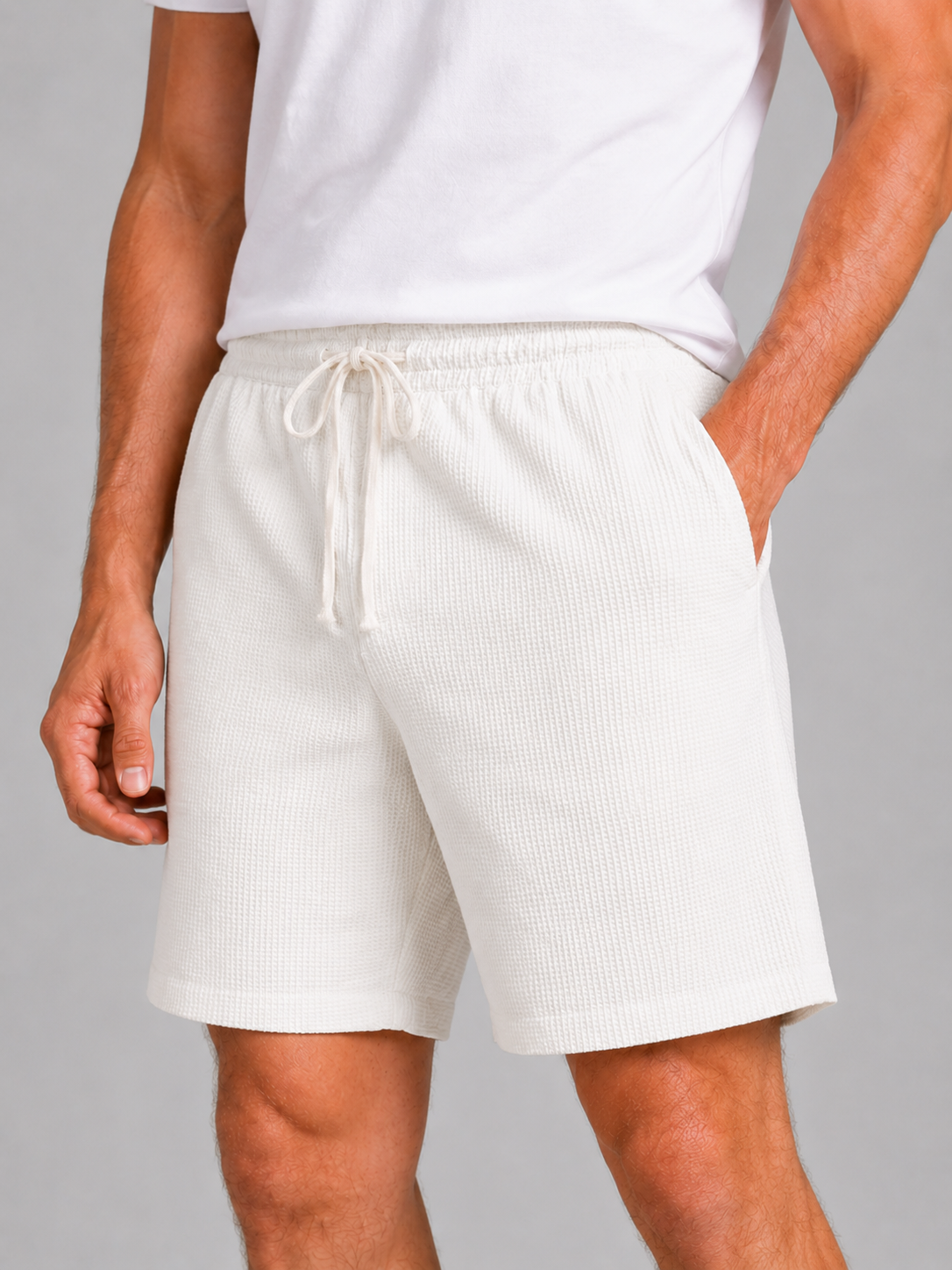 Close up of white waffle texture shorts showing breathable fabric and adjustable drawstring waistband
