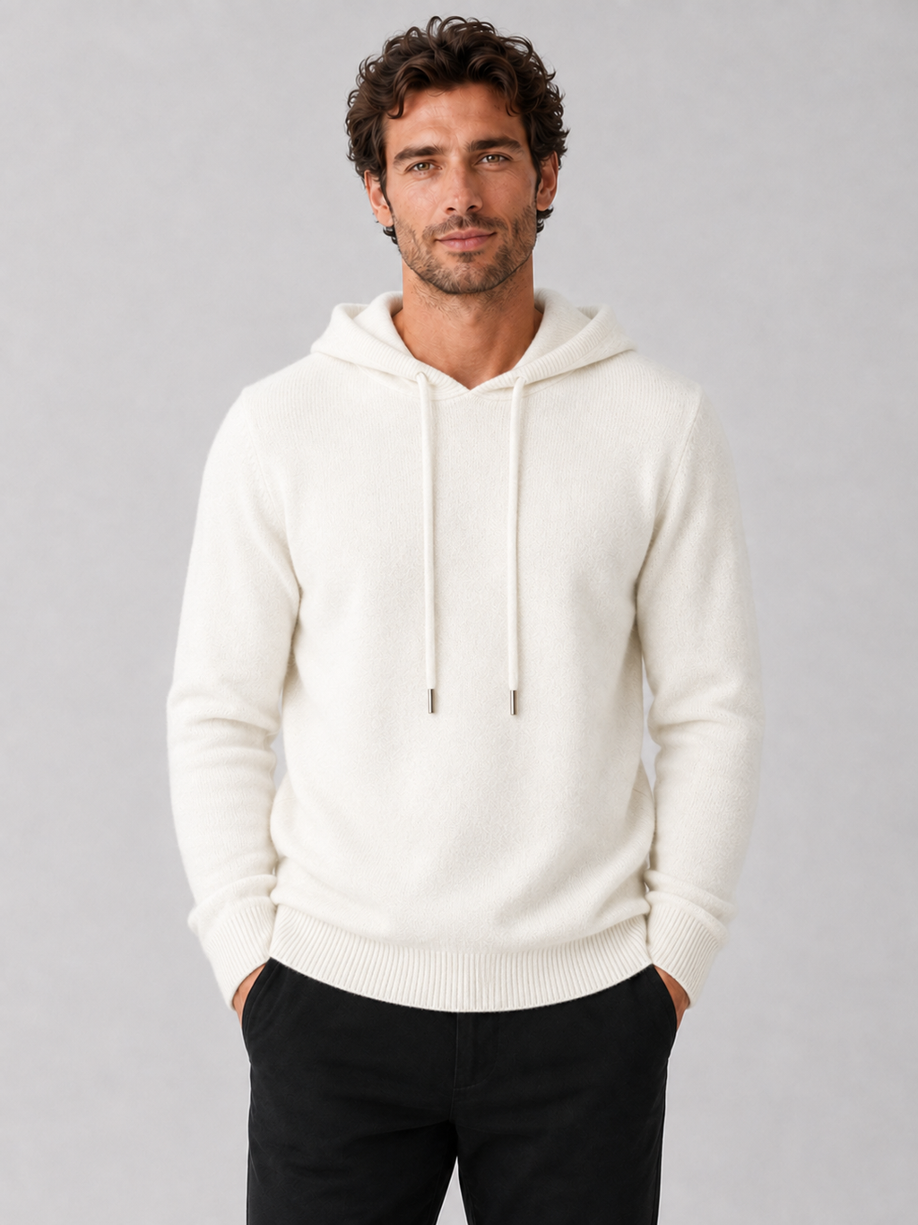 Front view of a man wearing a white wool hoodie sweater with a soft knit design, attached hood, and long sleeves