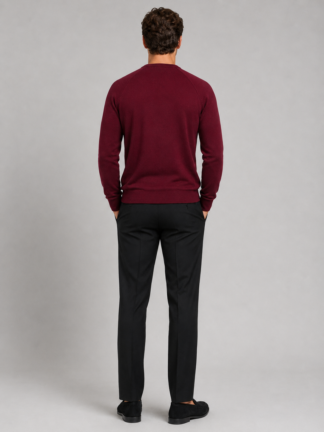 Back view of a man wearing a wine argyle sweater showing the crew neck, long sleeves, and comfortable fit