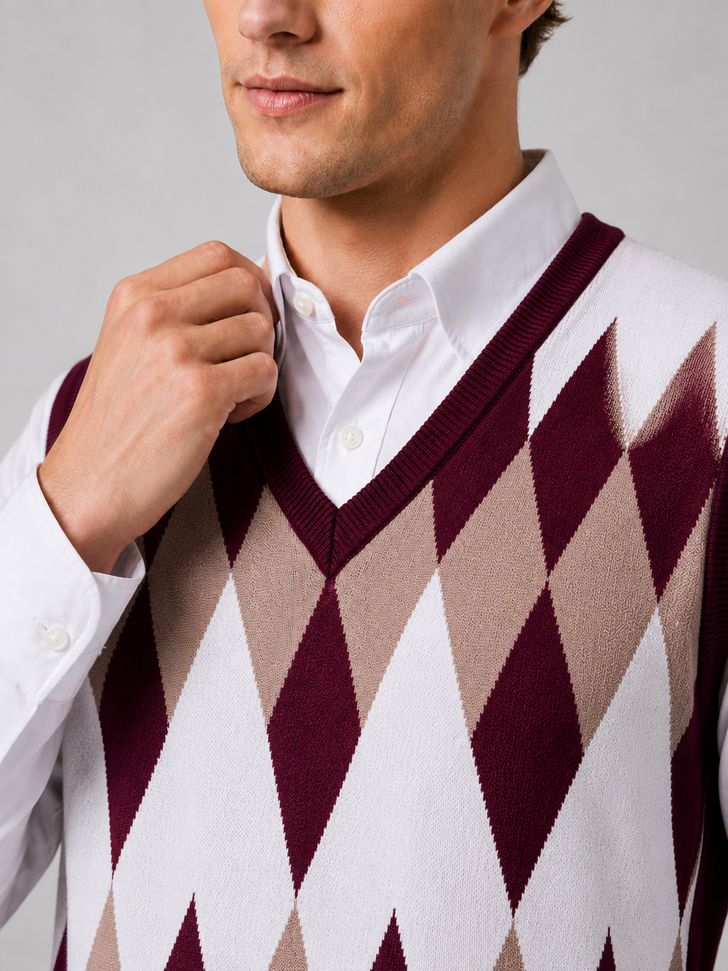 Close up of wine argyle sweater vest showing classic diamond knit pattern and refined v neck detail