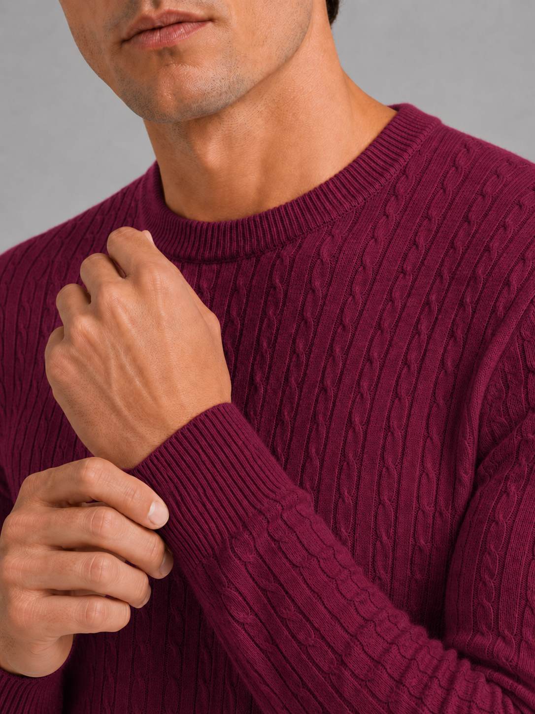 Close up of wine cable knit sweater showing soft textured fabric and clean crew neck detail