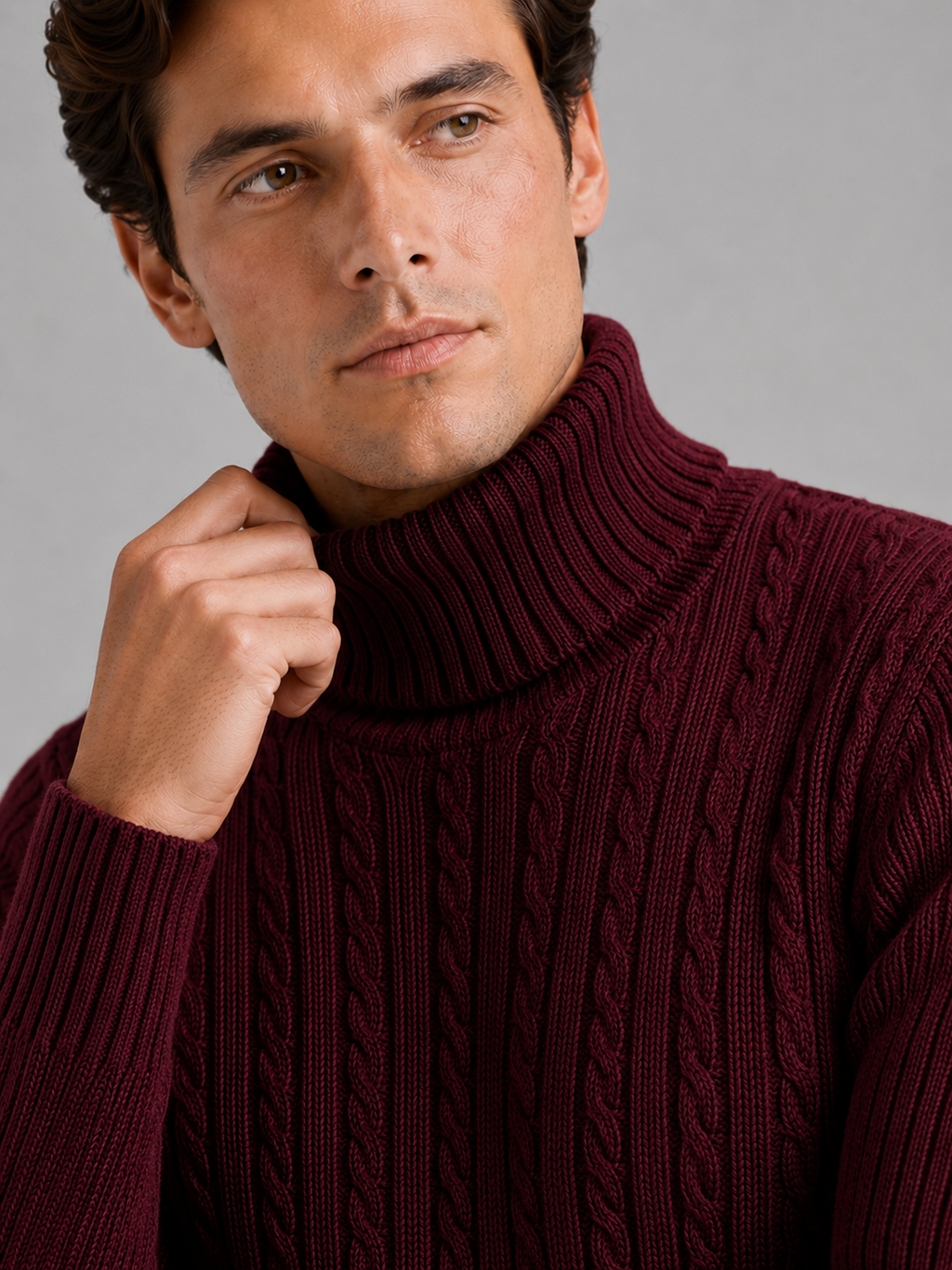 Close up of wine cable knit turtleneck showing thick textured fabric and warm collar detail