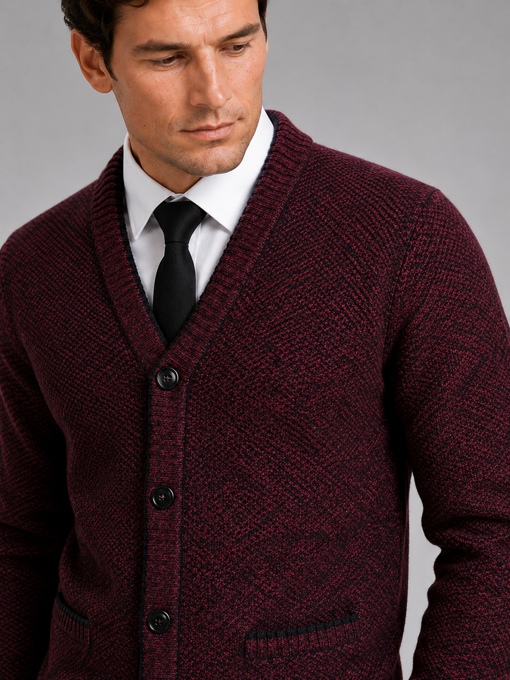 Close up of wine knit cardigan showing soft textured fabric and refined button front detail