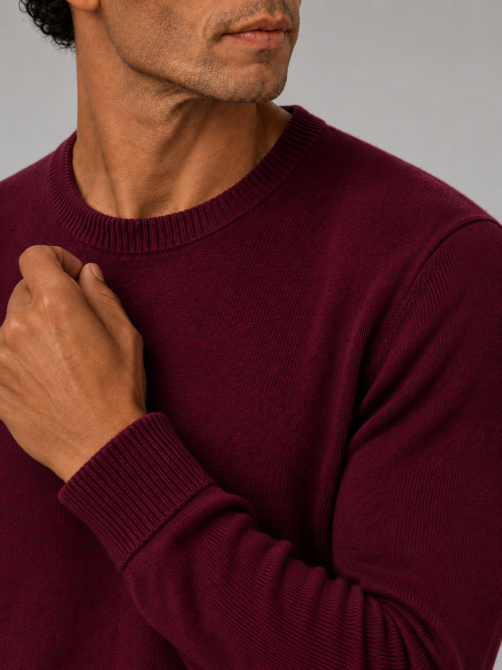 Close up of wine knit sweater showing soft lightweight fabric and clean crew neck detail
