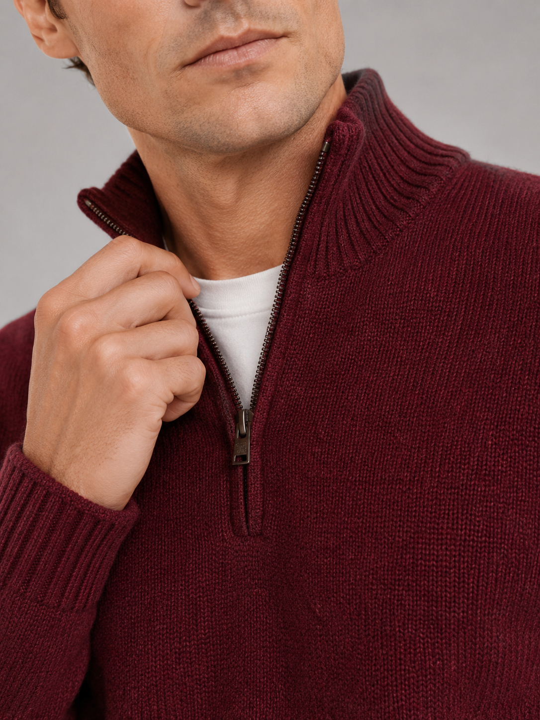 Close up of wine half zip sweater showing soft knit texture and refined zipper detail