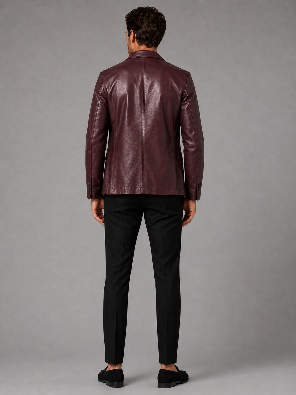 Back view of a man wearing a wine red leather blazer jacket showing the tailored slim fit, smooth leather finish, and structured silhouette