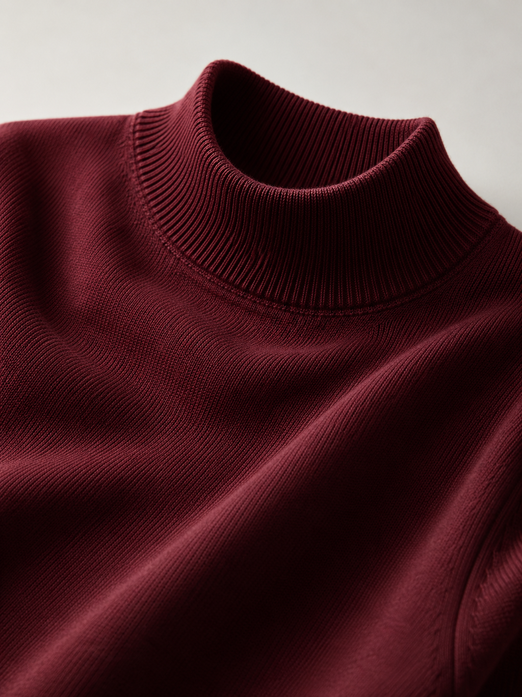 Close up of wine mock neck sweater showing soft knit texture and refined collar detail