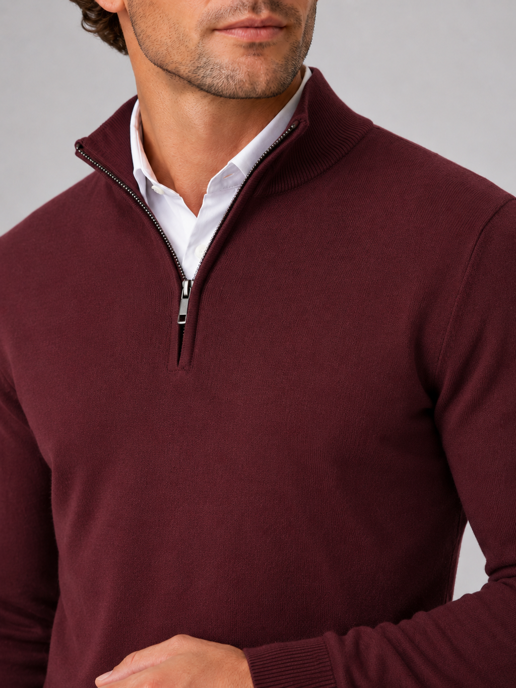Close up of wine quarter zip sweater showing soft knit texture and mock neck zipper detail