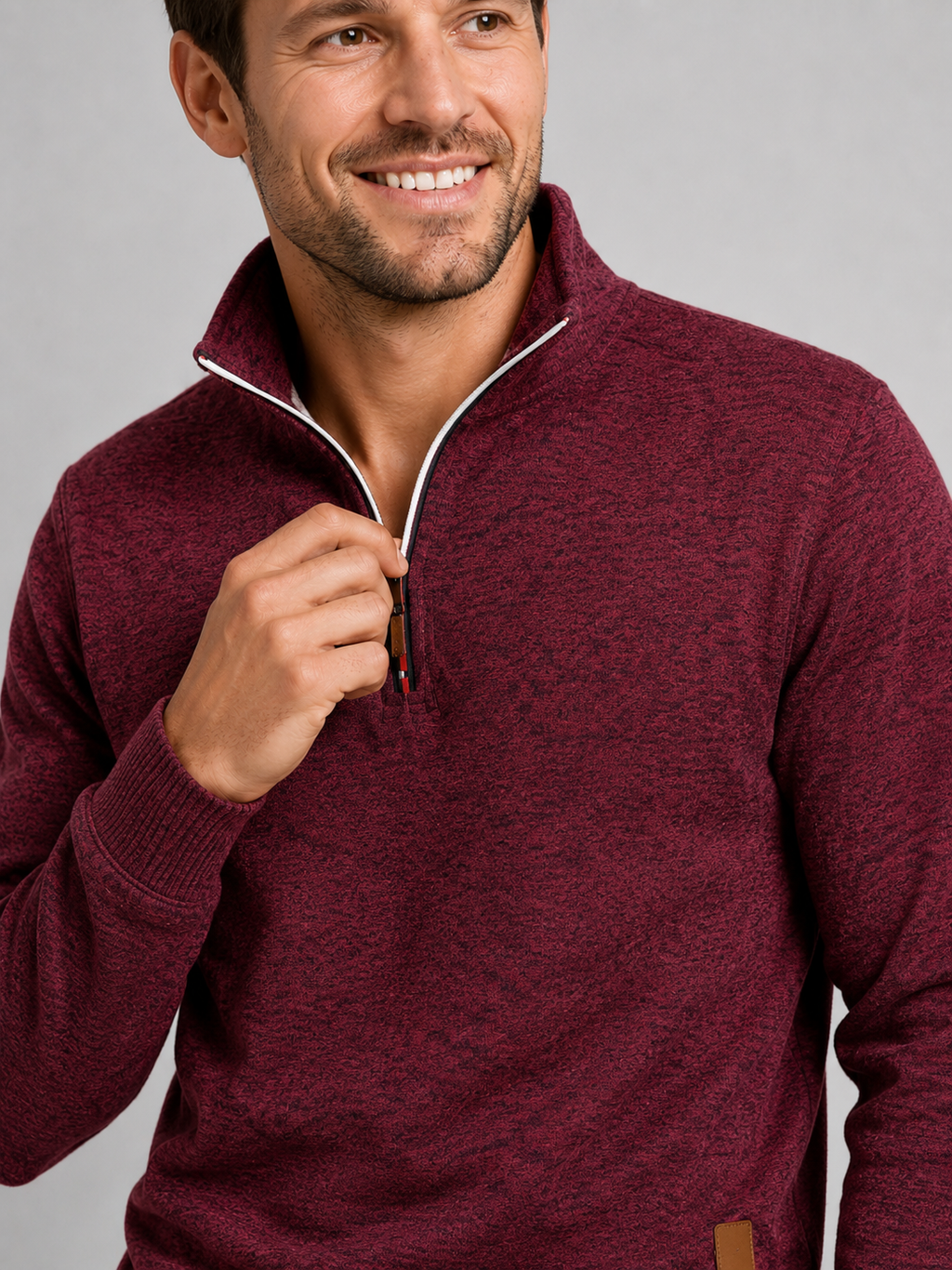 Close up of wine quarter zip sweater showing soft knit texture and stand collar zipper detail