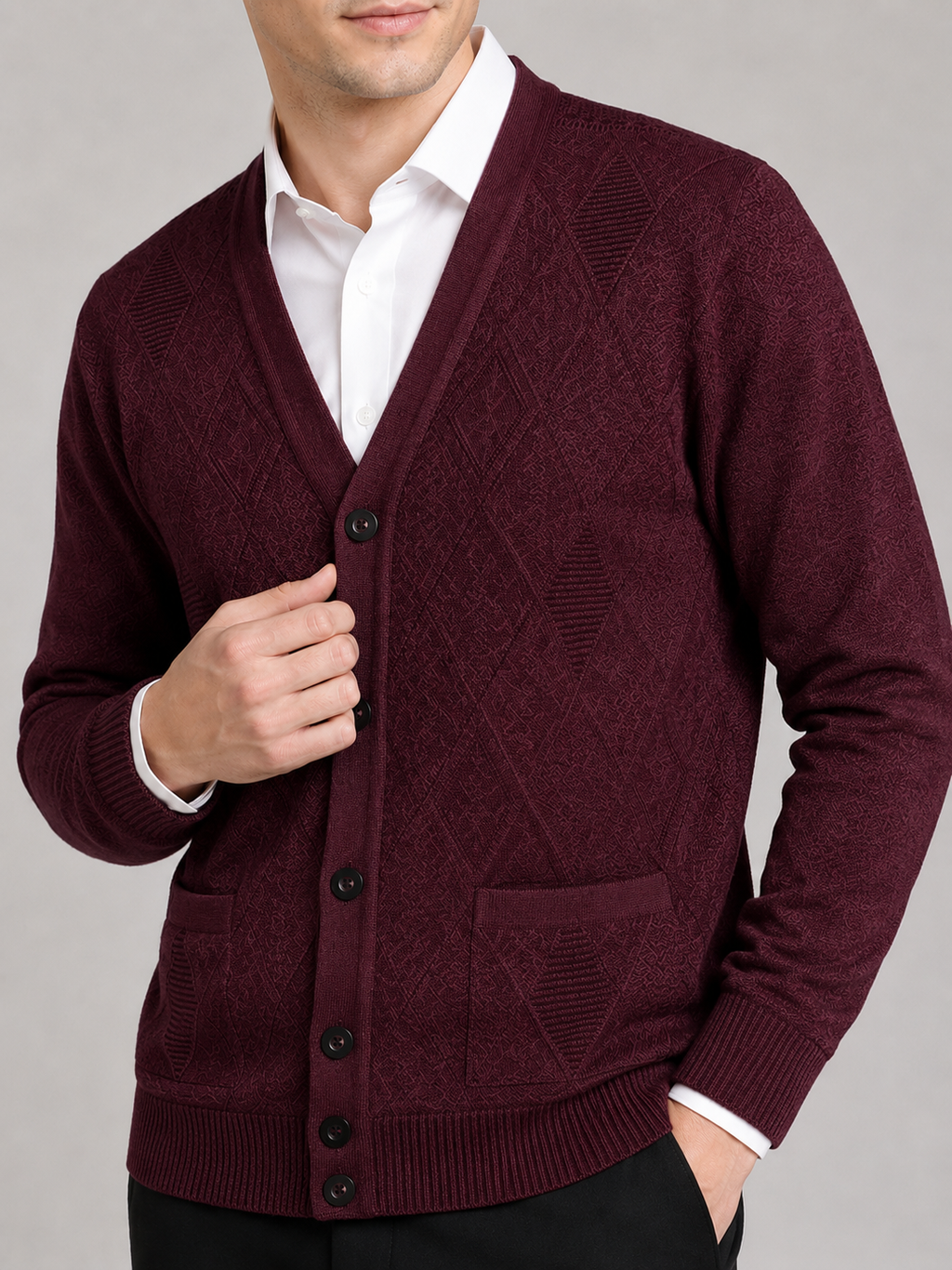 Close up of wine knit cardigan showing soft textured fabric and refined button front detail