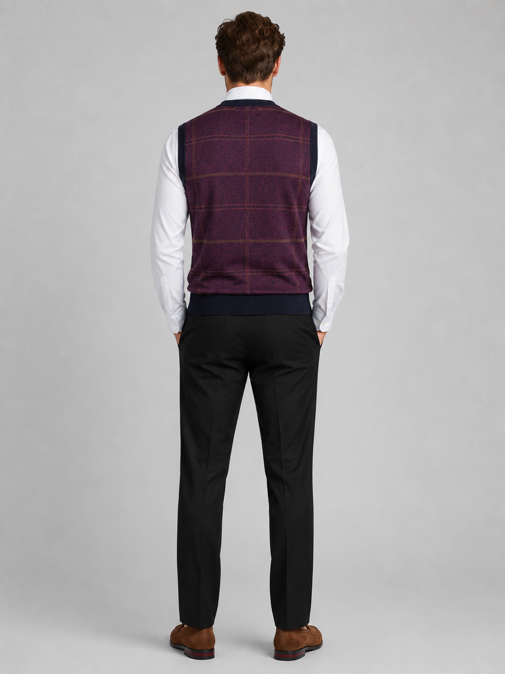 Back view of a man wearing a wine red V-neck sweater vest showing the sleeveless cut, warm knit fabric, and comfortable fit