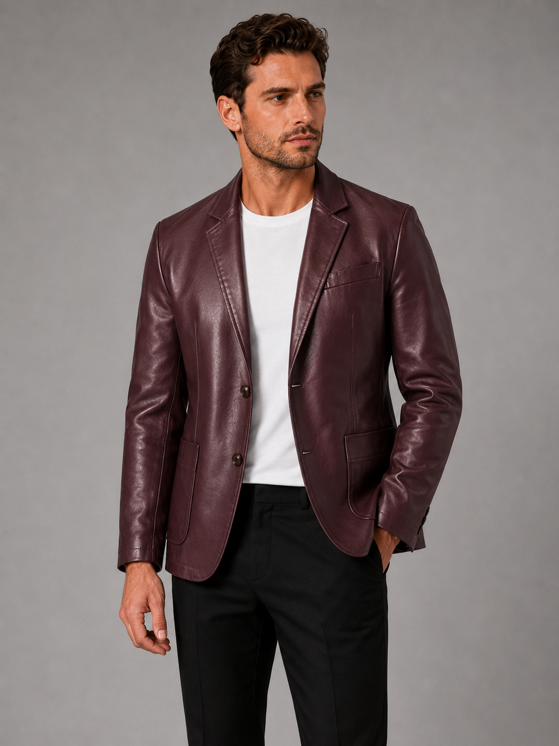 Front view of a man wearing a wine red leather blazer jacket with a slim fit, notched lapel, single-breasted design, and tailored silhouette