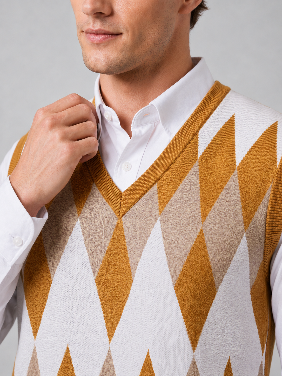 Close up of yellow argyle sweater vest showing classic diamond knit pattern and refined v neck detail