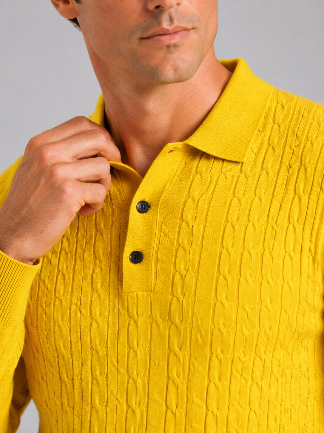Close up of yellow cable knit polo showing soft textured fabric and refined collar detail