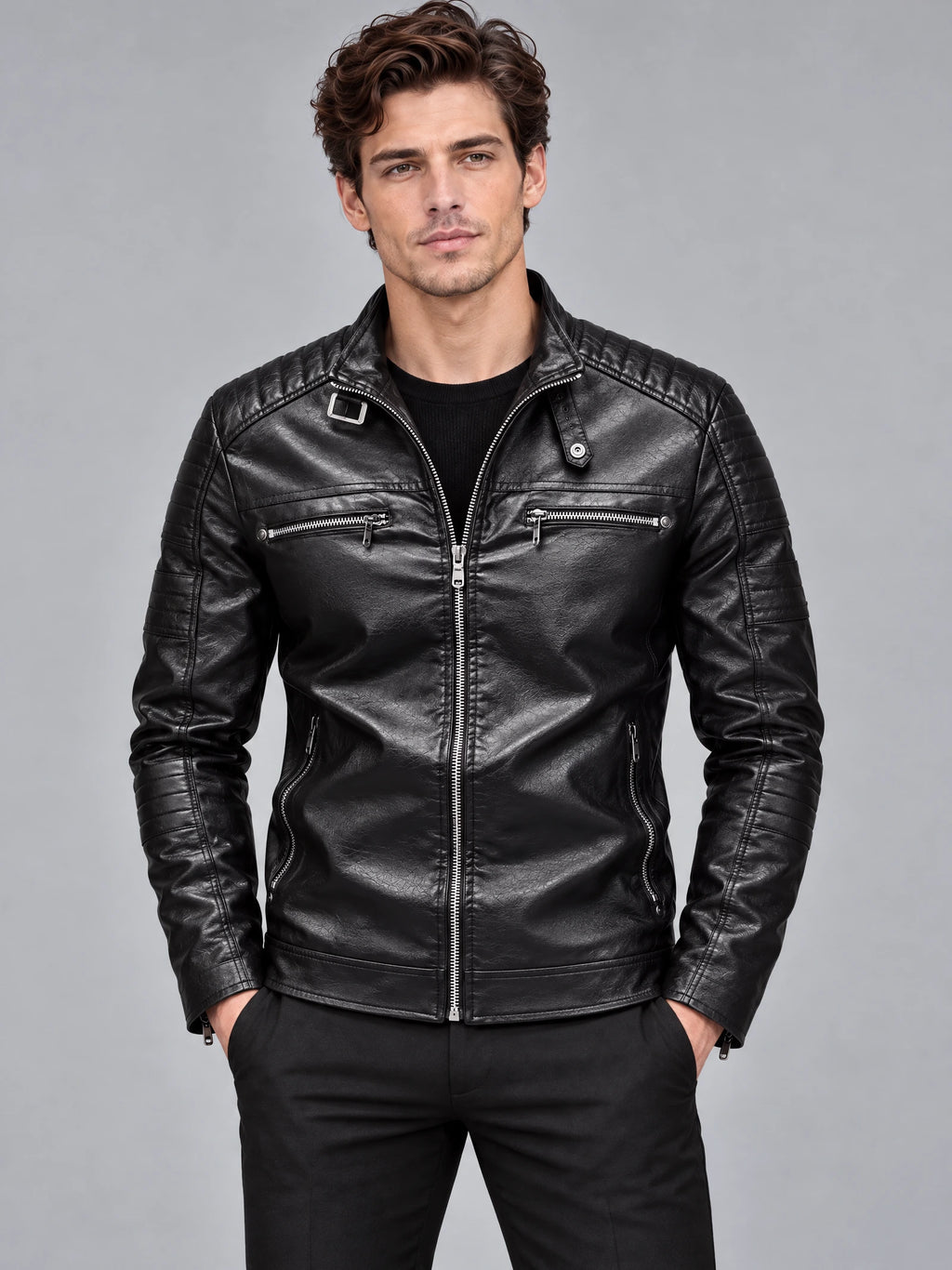 Model wearing a Black Biker Leather Jacket in a front studio view, with quilted shoulders and zippered pockets.